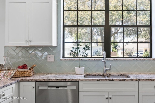 kitchen featuring a sink, white cabinetry, decorative backsplash, light stone countertops, and dishwasher