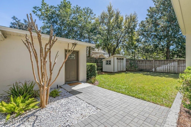 entrance to property with a patio, a lawn, fence, and stucco siding