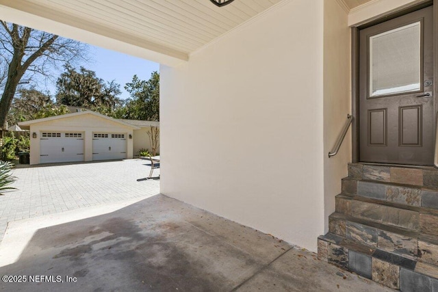 exterior space with a garage and stucco siding