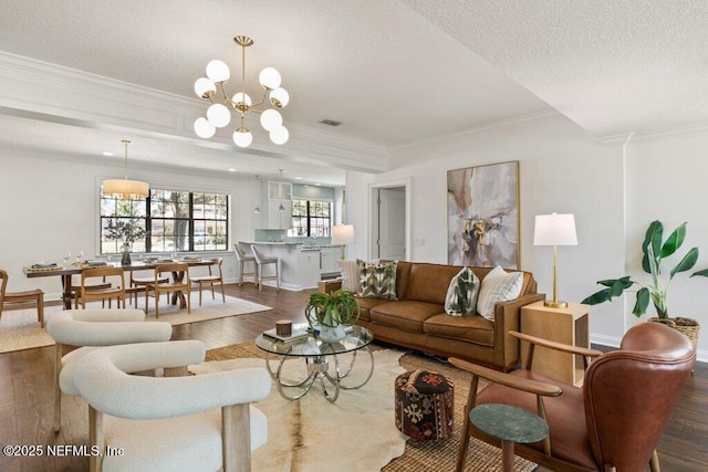 living room with visible vents, crown molding, a textured ceiling, and wood finished floors