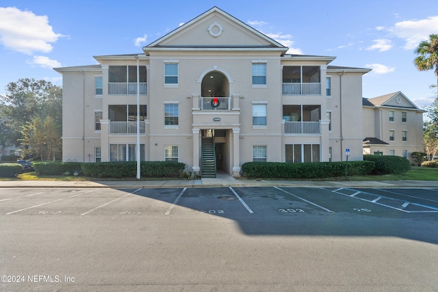 view of building exterior with uncovered parking