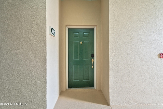 entrance to property featuring stucco siding