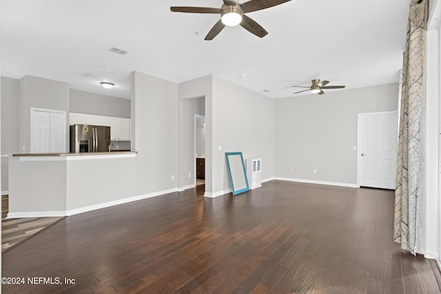 8601 Beach Blvd Unit 1007, Jacksonville, FL 32216 - unfurnished living room featuring a ceiling fan and dark wood-style flooring