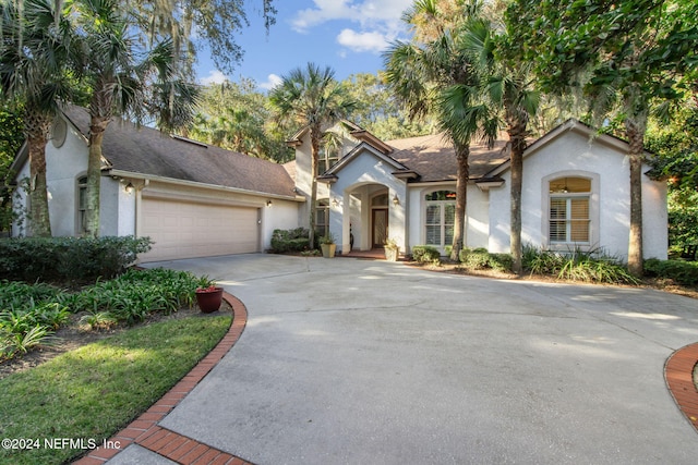 mediterranean / spanish-style house featuring a garage