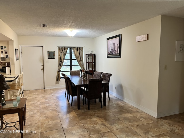 dining area with a textured ceiling