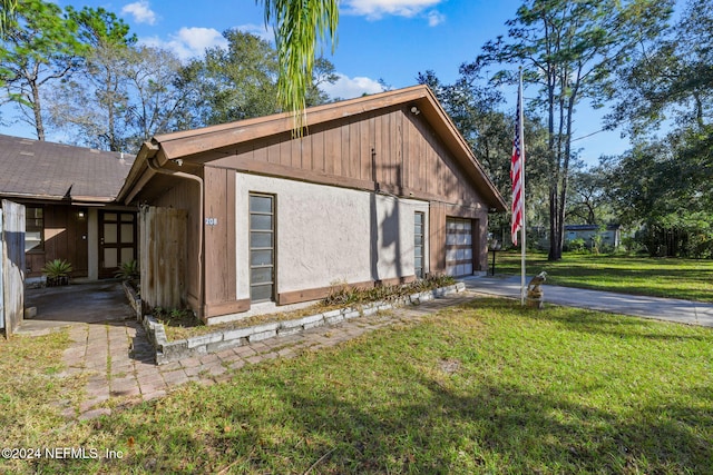 view of home's exterior featuring a garage and a yard