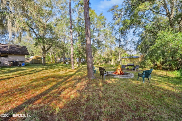 view of yard with an outdoor fire pit