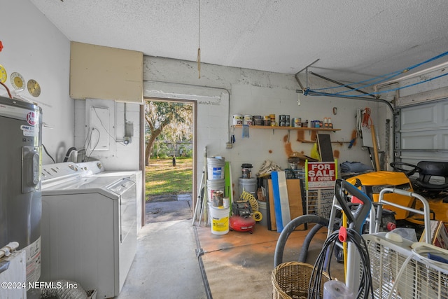 garage featuring washing machine and clothes dryer and water heater