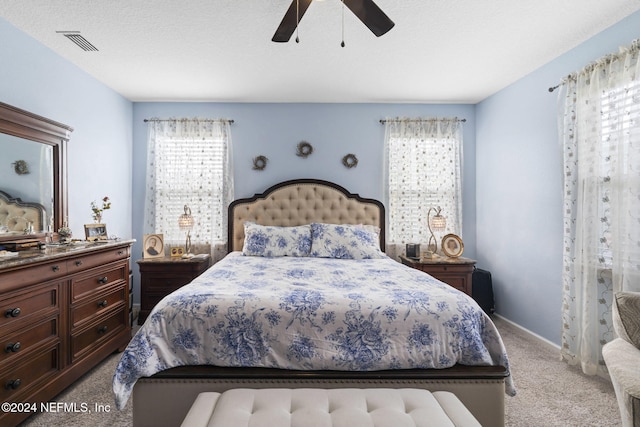 bedroom featuring ceiling fan and light colored carpet