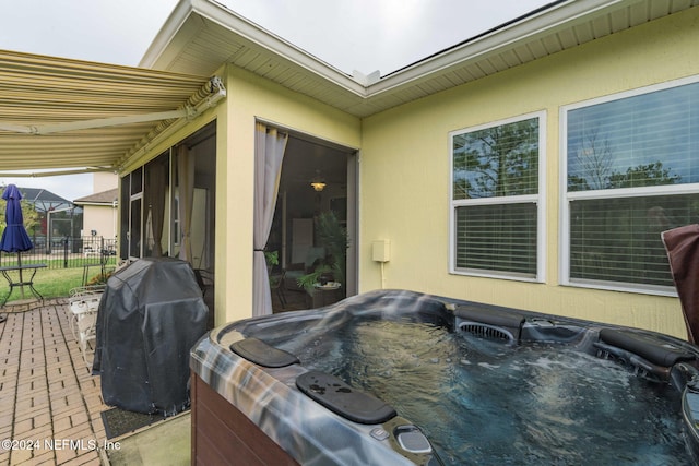 wooden deck with a patio, a hot tub, and grilling area