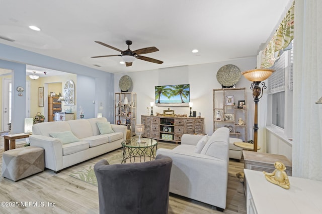 living room featuring light wood-type flooring and ceiling fan