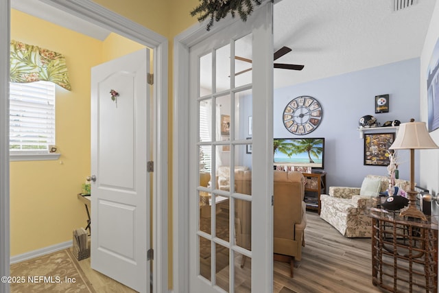 entryway featuring hardwood / wood-style floors, a textured ceiling, and ceiling fan