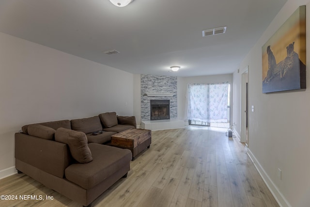 living room featuring light hardwood / wood-style floors and a fireplace