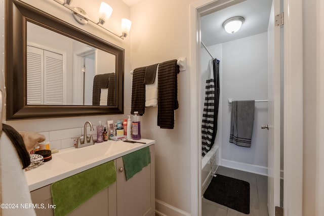 bathroom with tile patterned flooring, shower / tub combo, and vanity