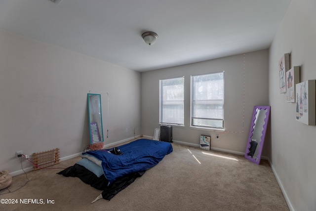 bedroom featuring light carpet