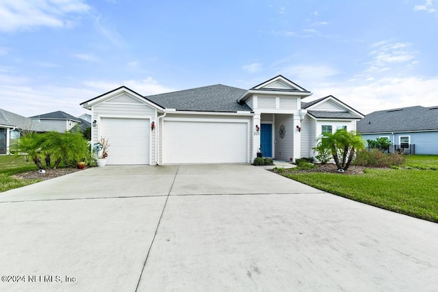 view of front of property with a front yard and a garage