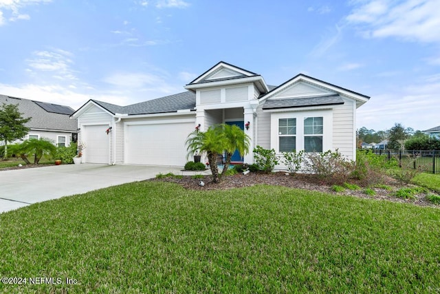 view of front of house with a front yard and a garage