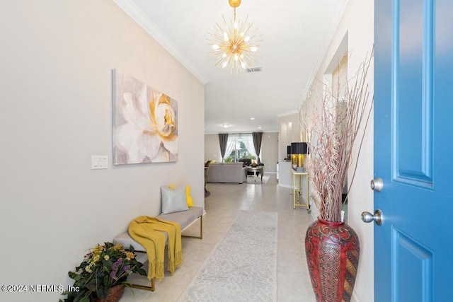 entrance foyer with light tile patterned floors, crown molding, and a chandelier