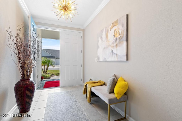 entryway featuring a notable chandelier, ornamental molding, and light tile patterned floors