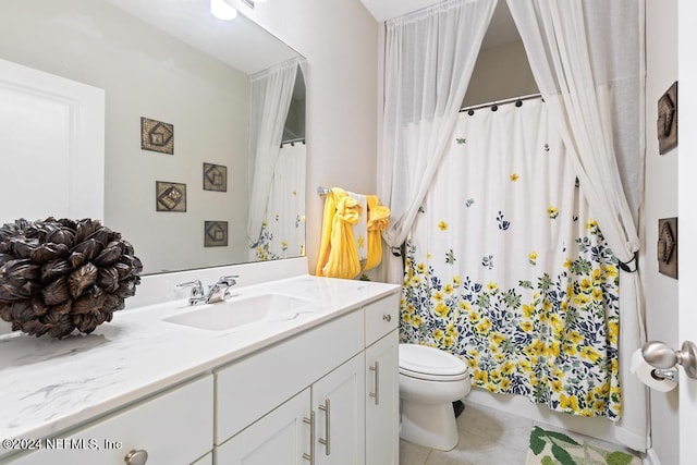 bathroom featuring tile patterned floors, vanity, and toilet