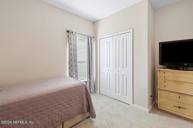 carpeted bedroom with a closet