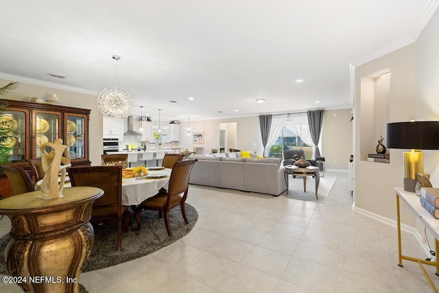 dining room featuring a chandelier, light tile patterned floors, and ornamental molding