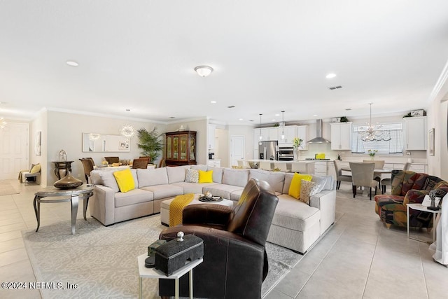 living room with crown molding, light tile patterned flooring, and an inviting chandelier