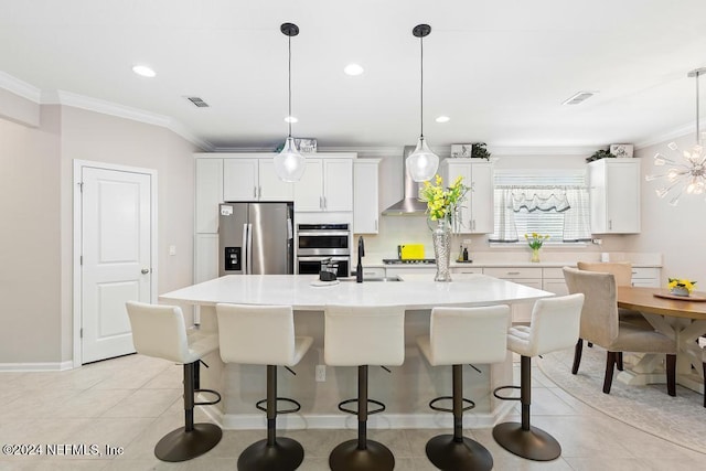 kitchen with decorative light fixtures, a center island, stainless steel appliances, and white cabinetry