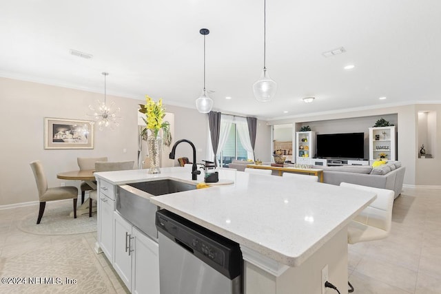 kitchen featuring decorative light fixtures, white cabinetry, stainless steel dishwasher, and a kitchen island with sink