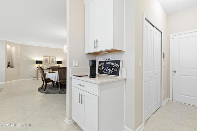 kitchen featuring white cabinetry and light tile patterned floors