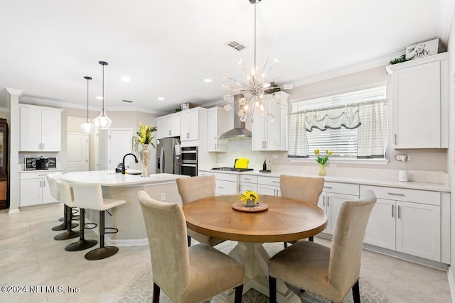 dining space featuring a chandelier, sink, ornamental molding, and light tile patterned flooring