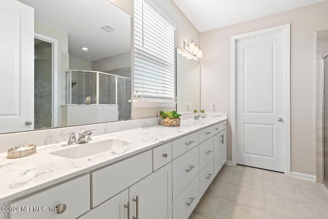 bathroom featuring tile patterned floors, vanity, and an enclosed shower