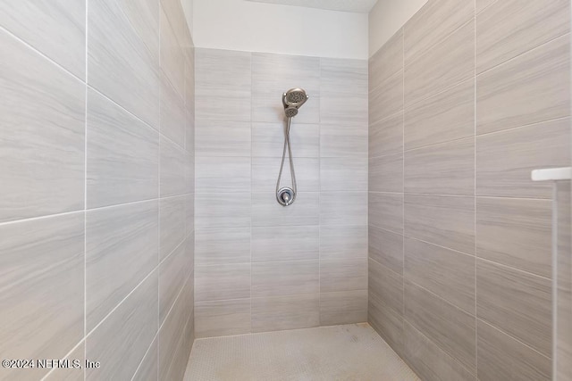 bathroom with a tile shower