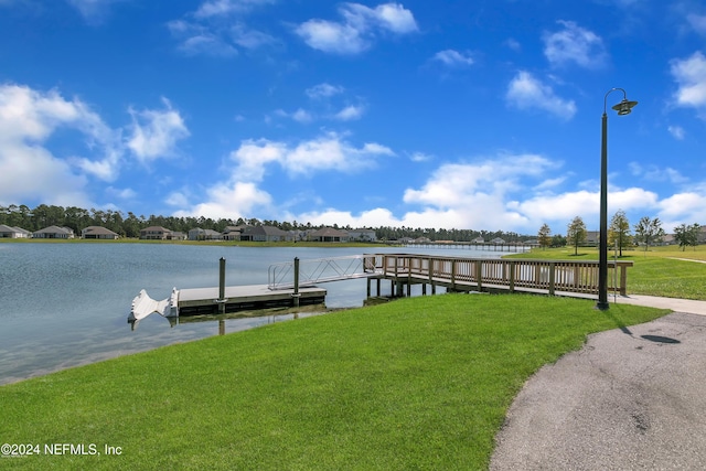 dock area with a yard and a water view