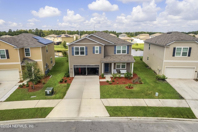 view of property with a garage and a front yard