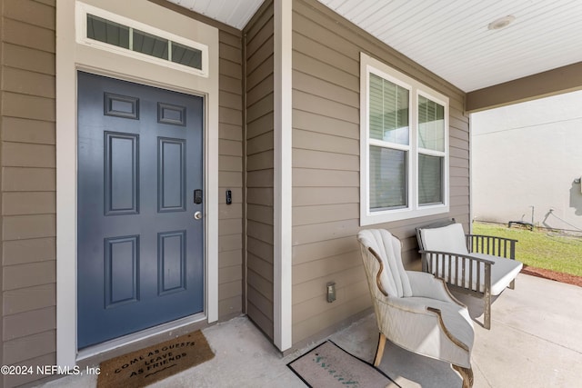 view of exterior entry with covered porch