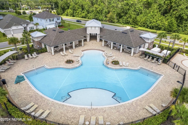 pool featuring a patio area and fence