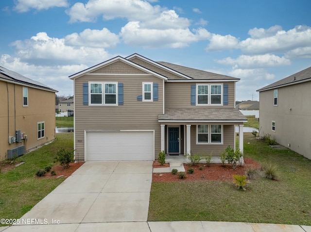 view of front of house featuring an attached garage, a front lawn, and concrete driveway