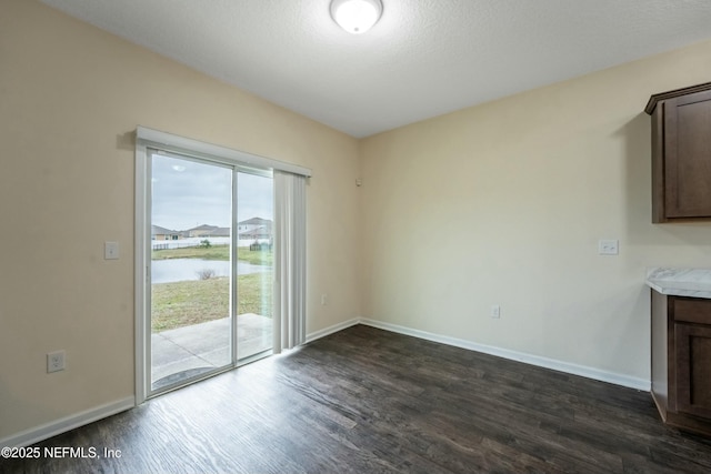 interior space featuring dark wood-style flooring and baseboards