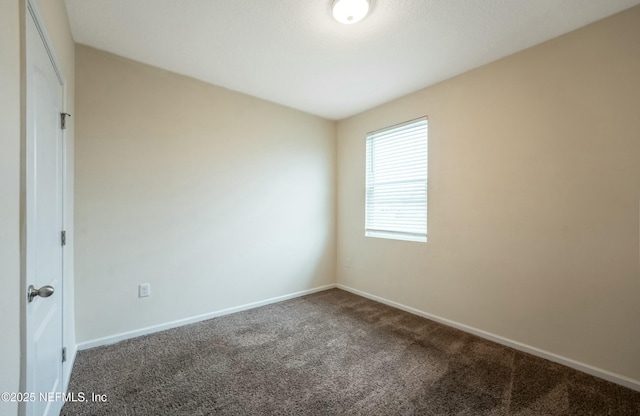 unfurnished room with carpet and baseboards