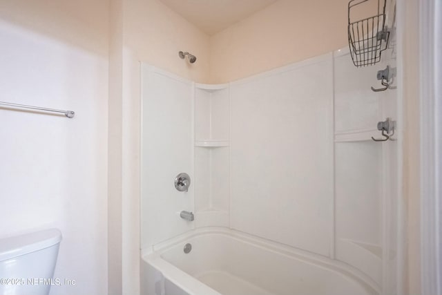 bathroom featuring tub / shower combination and toilet