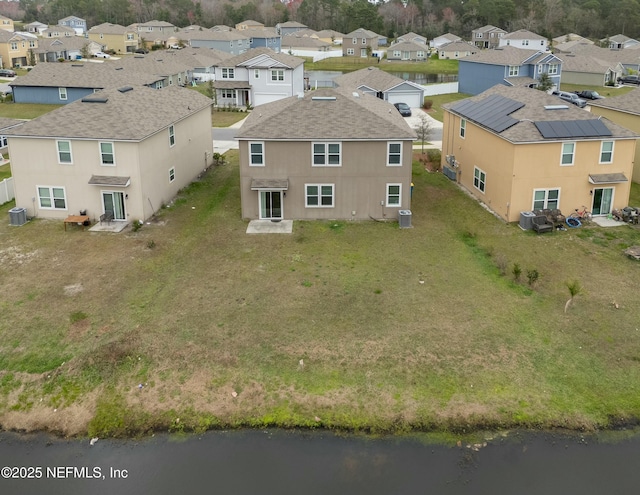 birds eye view of property with a residential view and a water view