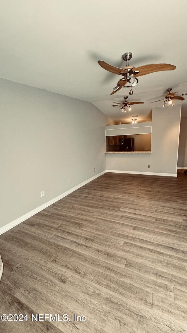 unfurnished living room with hardwood / wood-style floors, ceiling fan, and lofted ceiling