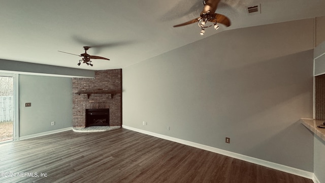 unfurnished living room with hardwood / wood-style flooring, a brick fireplace, ceiling fan, and lofted ceiling