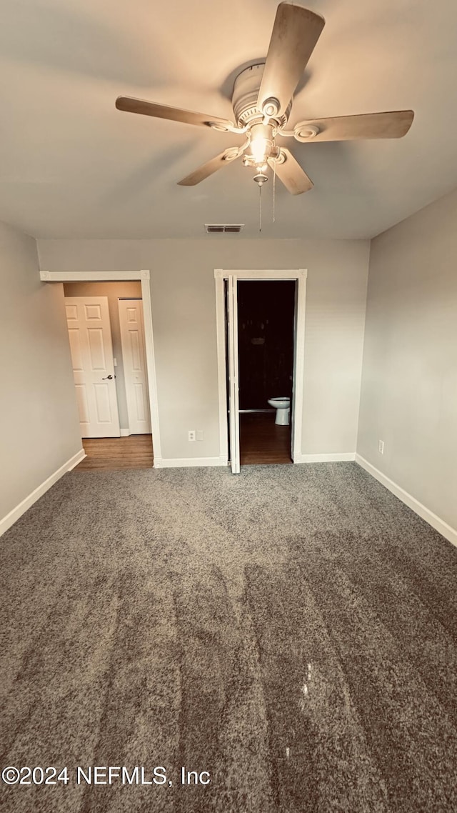 unfurnished bedroom featuring carpet, ceiling fan, and a closet