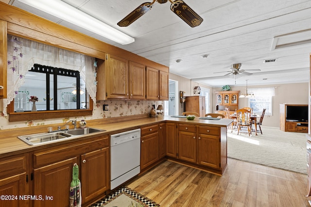 kitchen with kitchen peninsula, white dishwasher, ceiling fan, sink, and light hardwood / wood-style floors