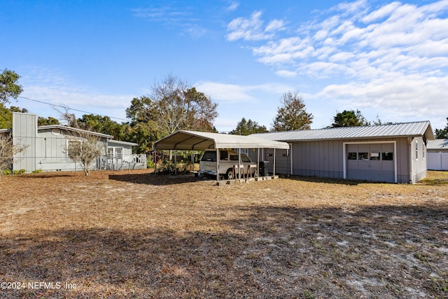 exterior space featuring an outbuilding, a garage, and a carport