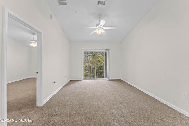 carpeted spare room featuring ceiling fan and vaulted ceiling