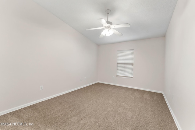 spare room featuring carpet floors and ceiling fan