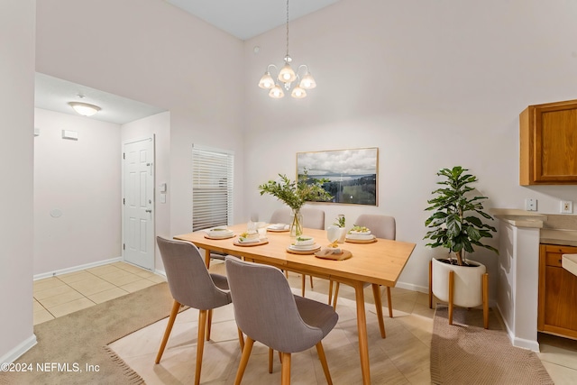 tiled dining room featuring a towering ceiling and a notable chandelier